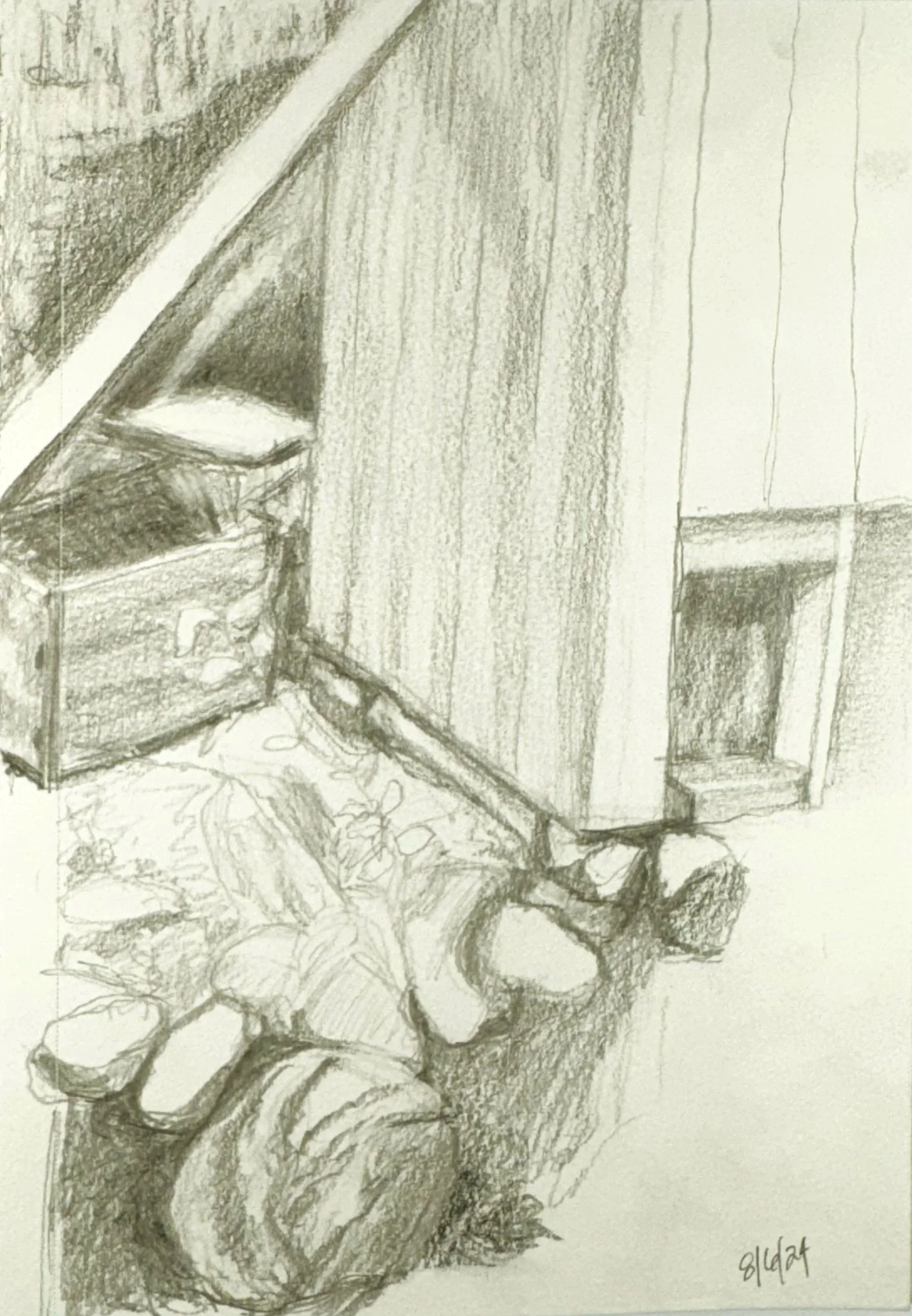 A pencil sketch of a person sitting on a stone wall, reading a book, with natural surroundings and a white building in the background.