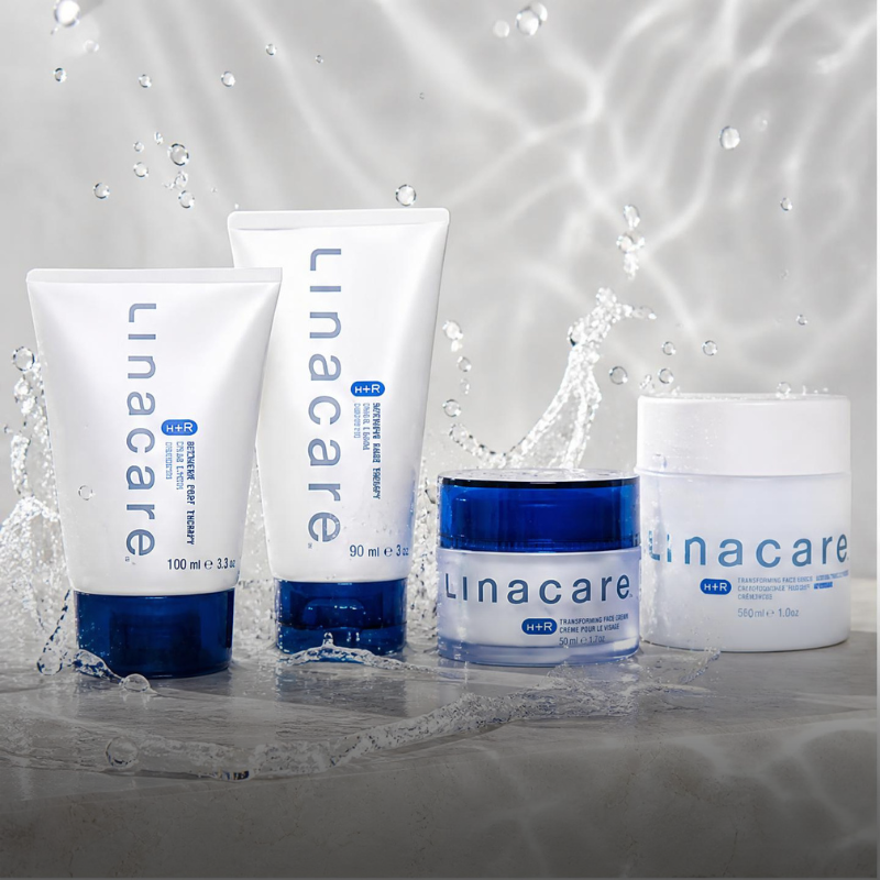 Collection of Linacare skincare products with splashing water, including tubes and jars in white and blue packaging.