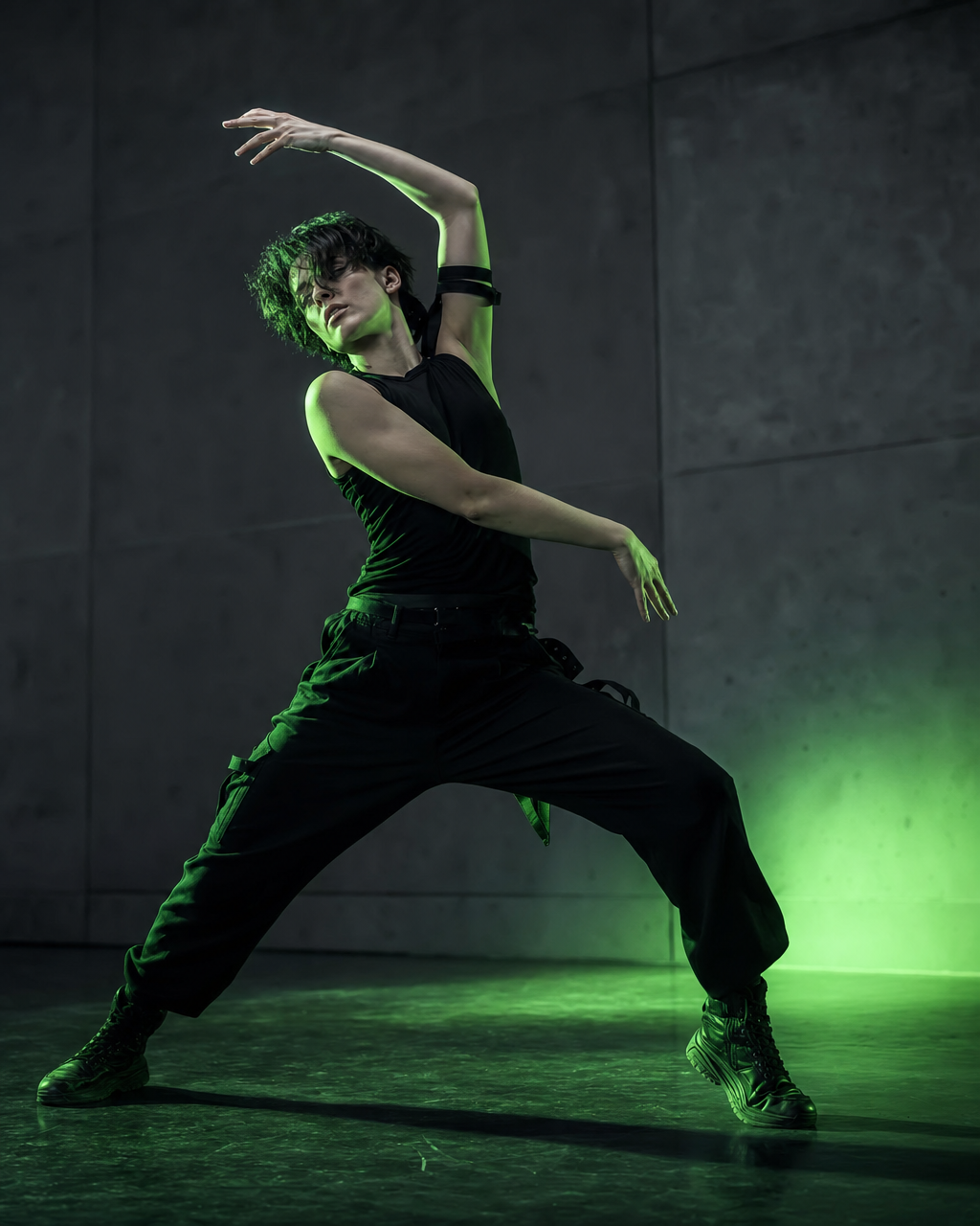 Dancer striking a powerful audition pose under electric lime light