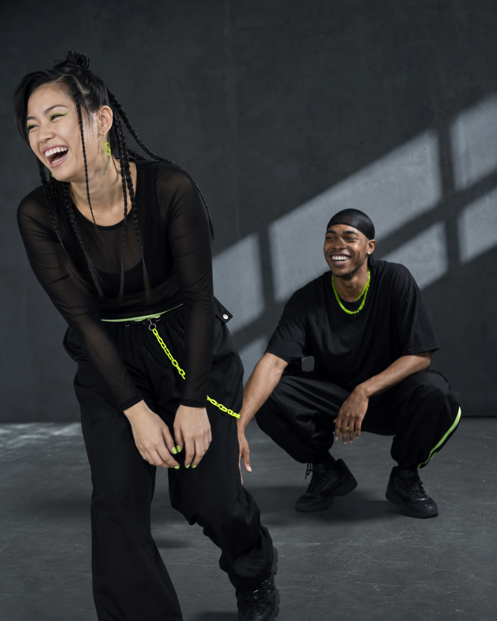 Two dancers laughing together between choreography takes