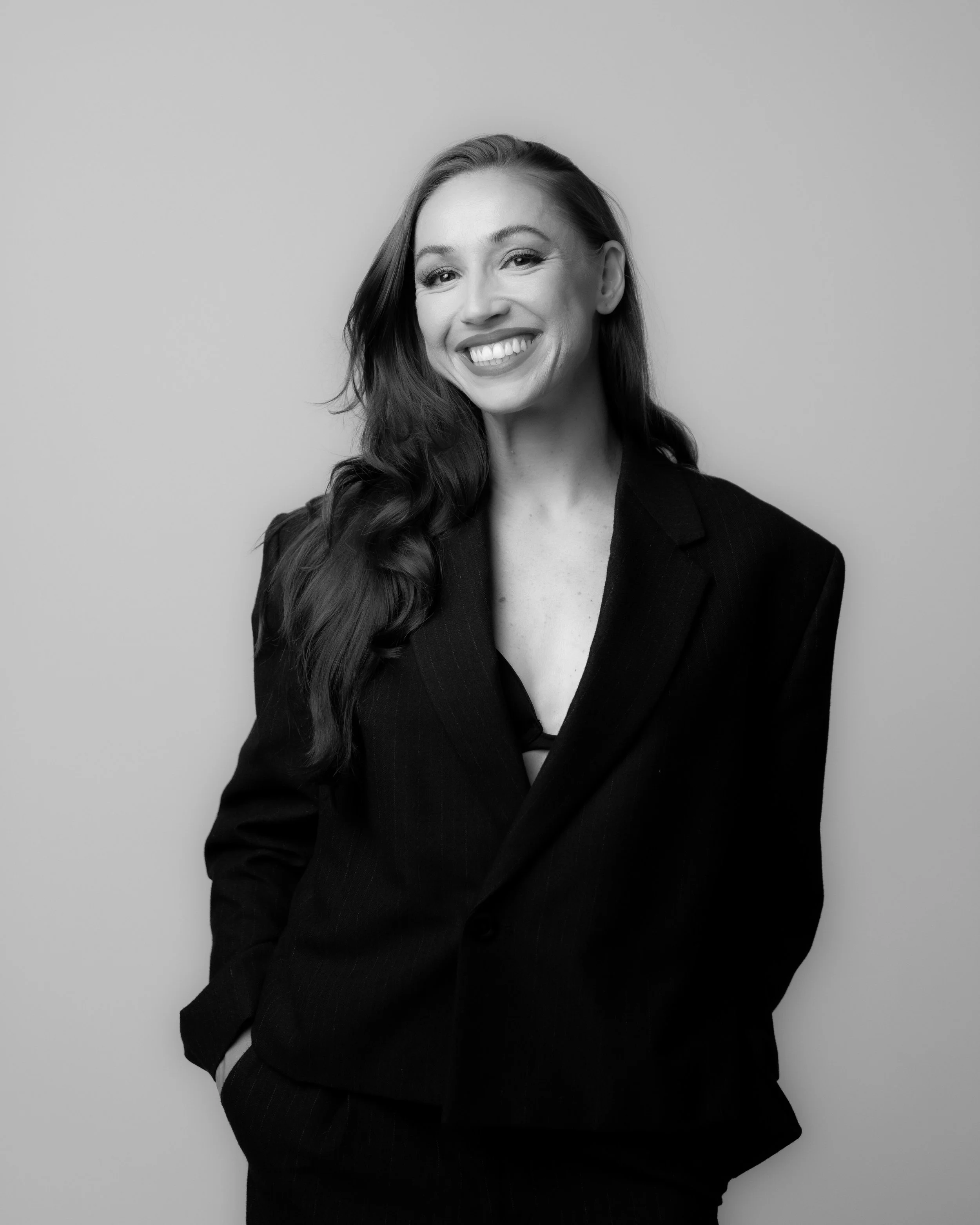 Skylar Schultz, founder and creative mentor at SJ Entertainment, smiling in a black blazer.