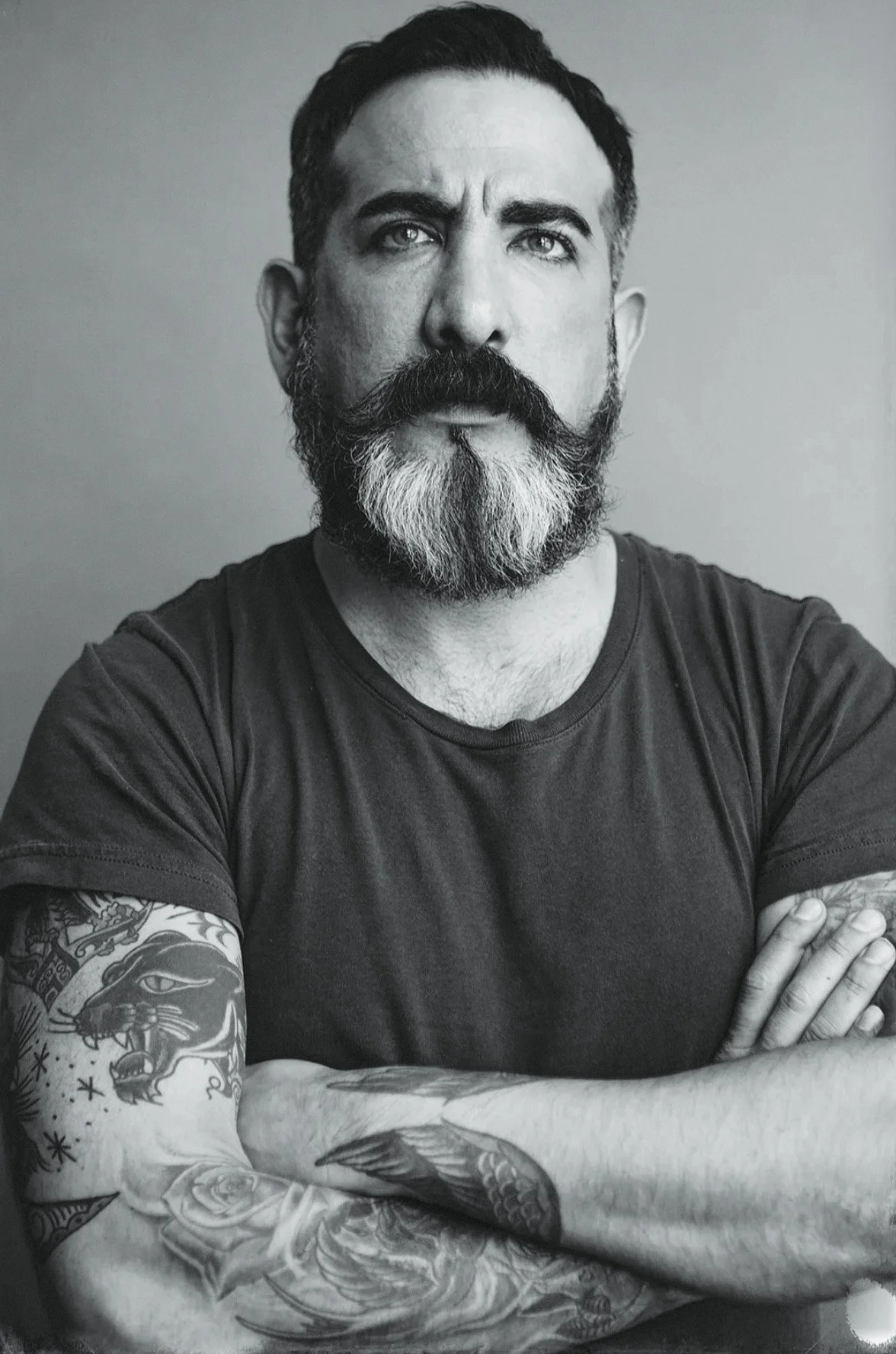 Kevin Christiana - Denim Designer crossing arms looking over camera