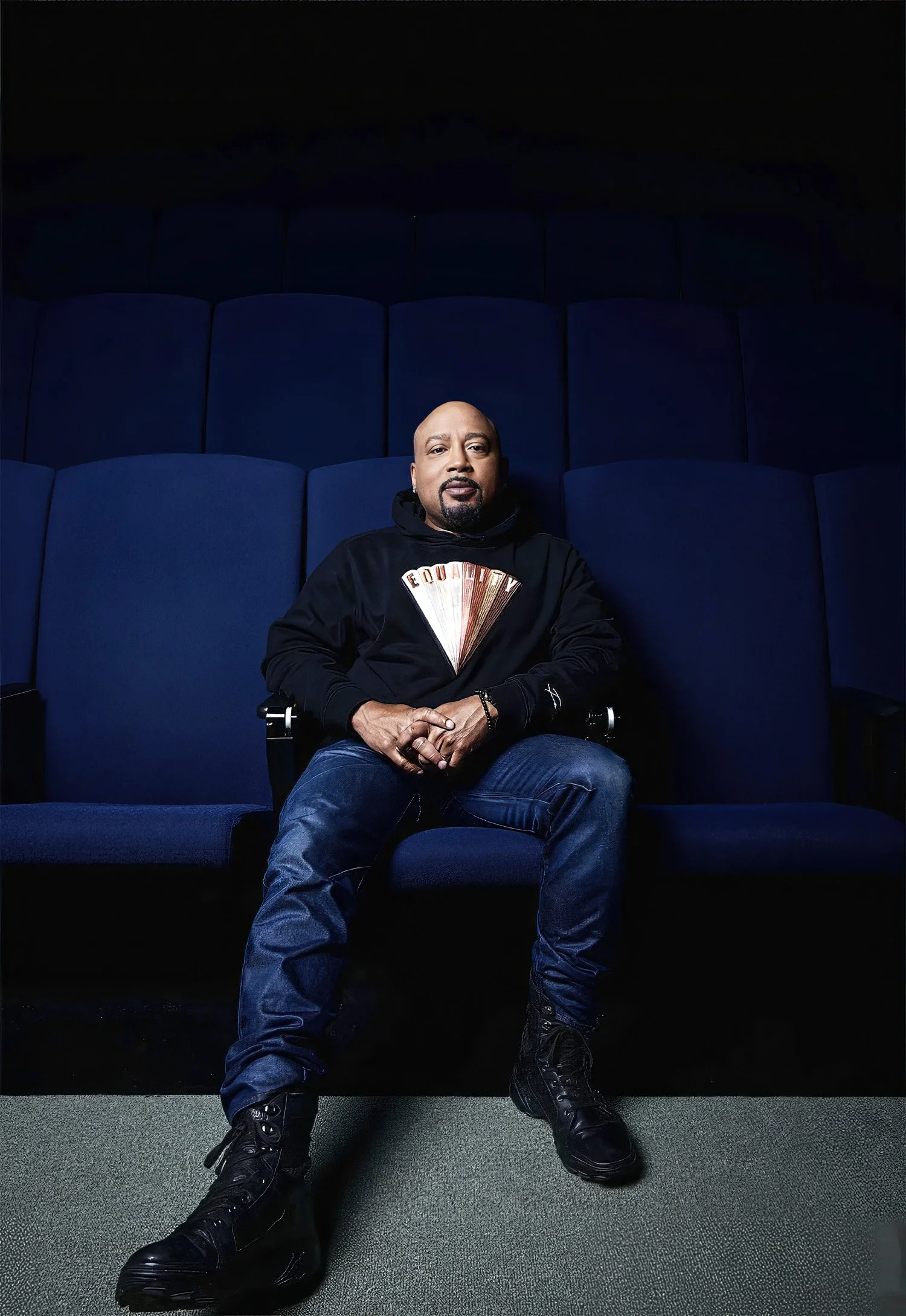 Daymond John sitting in blue theater chair