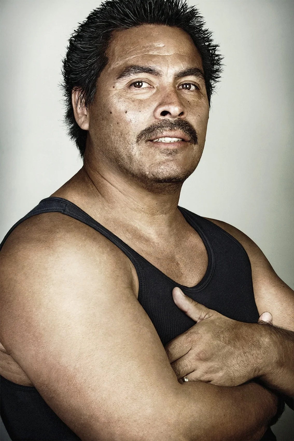 Side-by-side Skin Deep portraits of Marcos Luna with and without his tattoos.