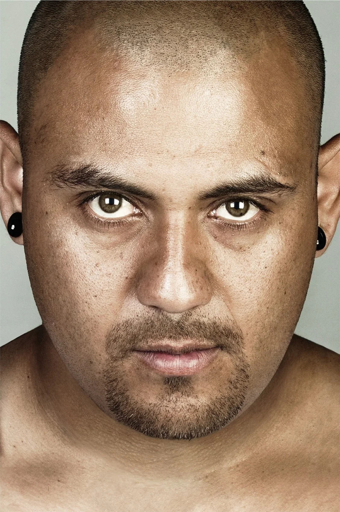 Portrait of Francisco Flores with his tattoos digitally removed.