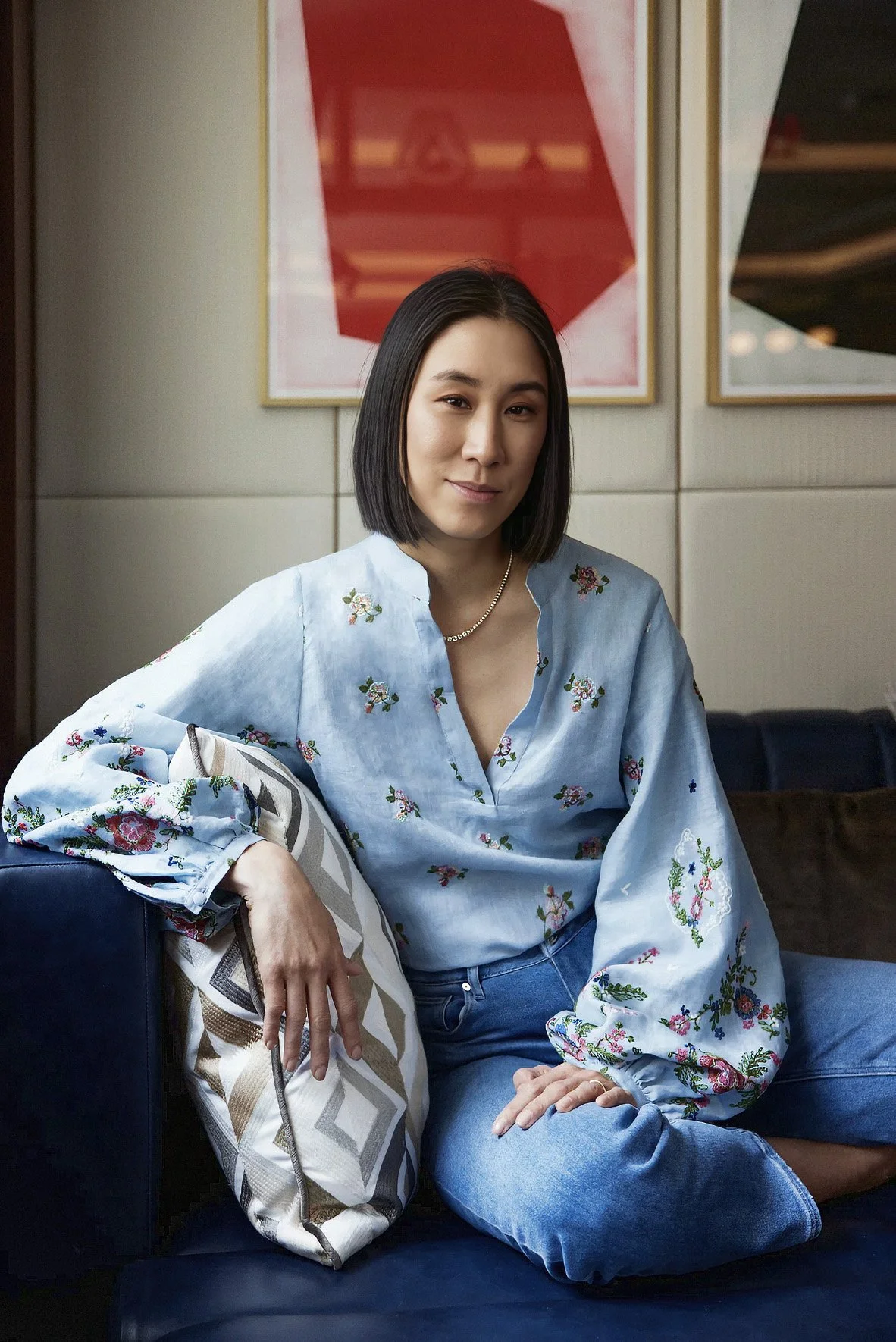 Eva Chen-Author sitting on a blue couch