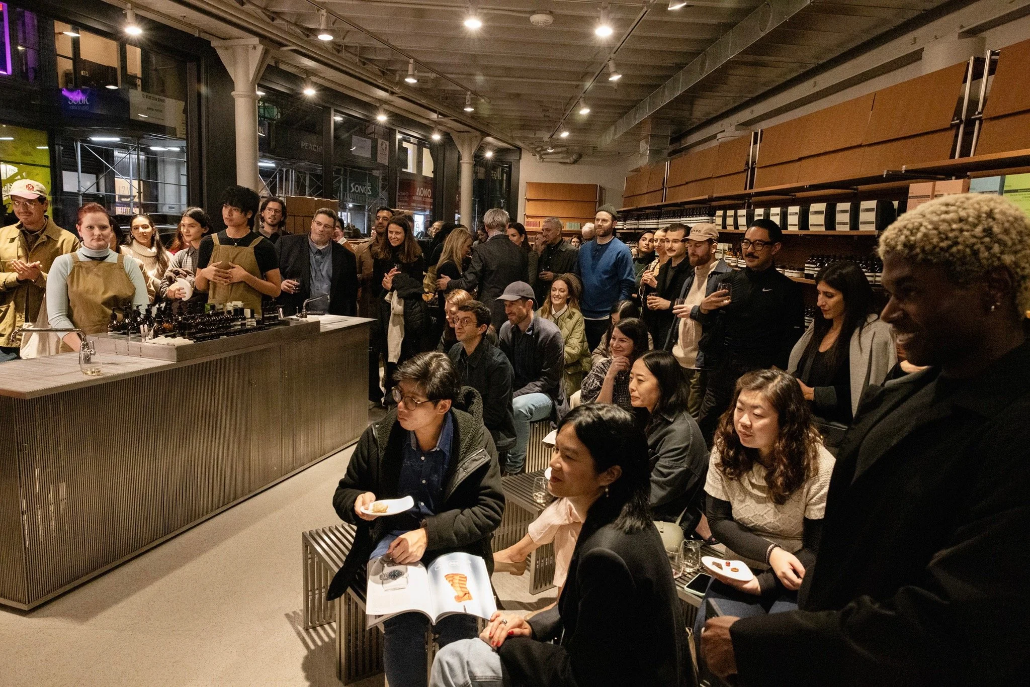Audience members watching a panel discussion inside Aesop’s NoMad store in New York.