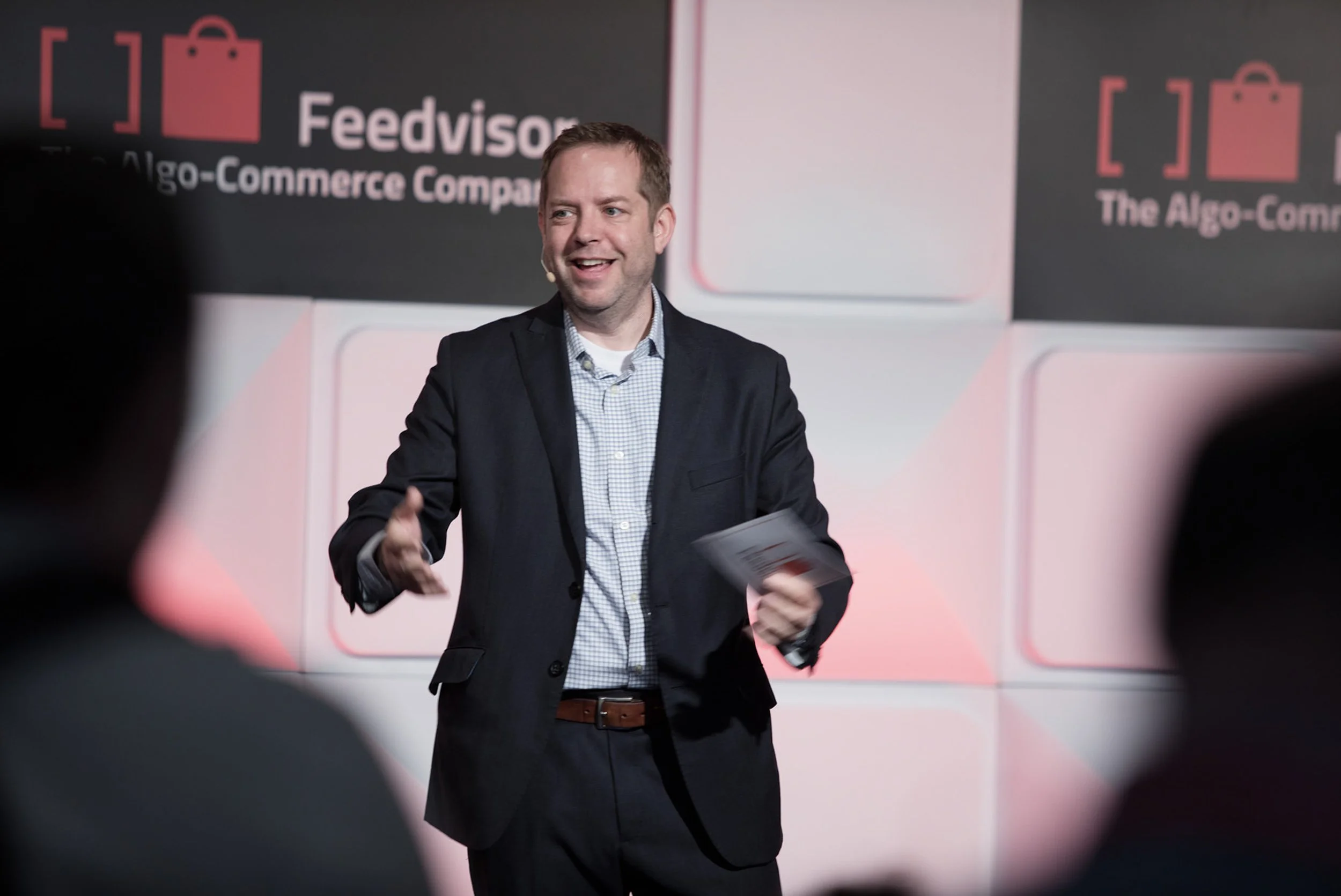 Conference speaker presenting on stage at the Amazon Professional Sellers’ Summit.