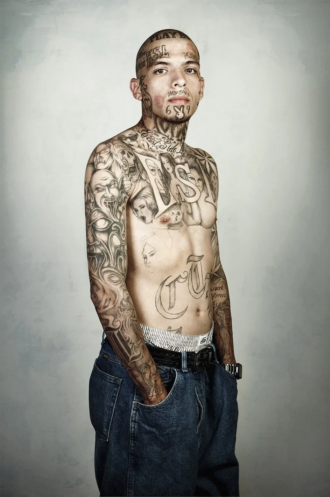 Portrait of Dennis Zamoran with visible facial and body tattoos.