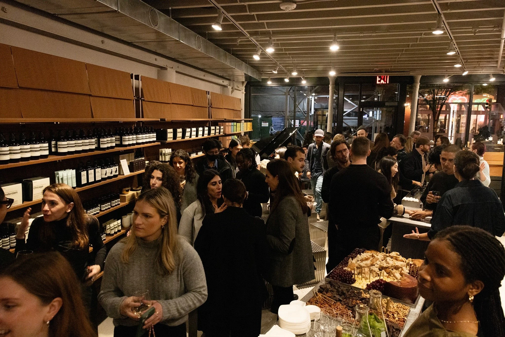 Guests gathering and networking inside Aesop’s NoMad store during an evening event with Wallpaper*.