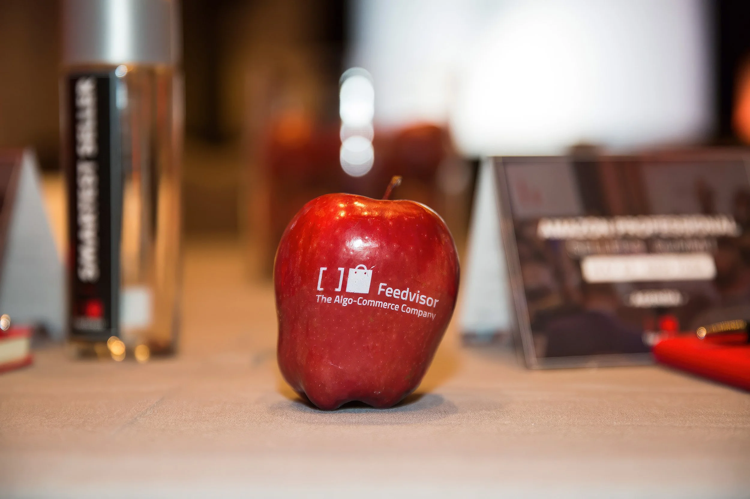 Feedvisor-branded apple displayed as a conference detail.