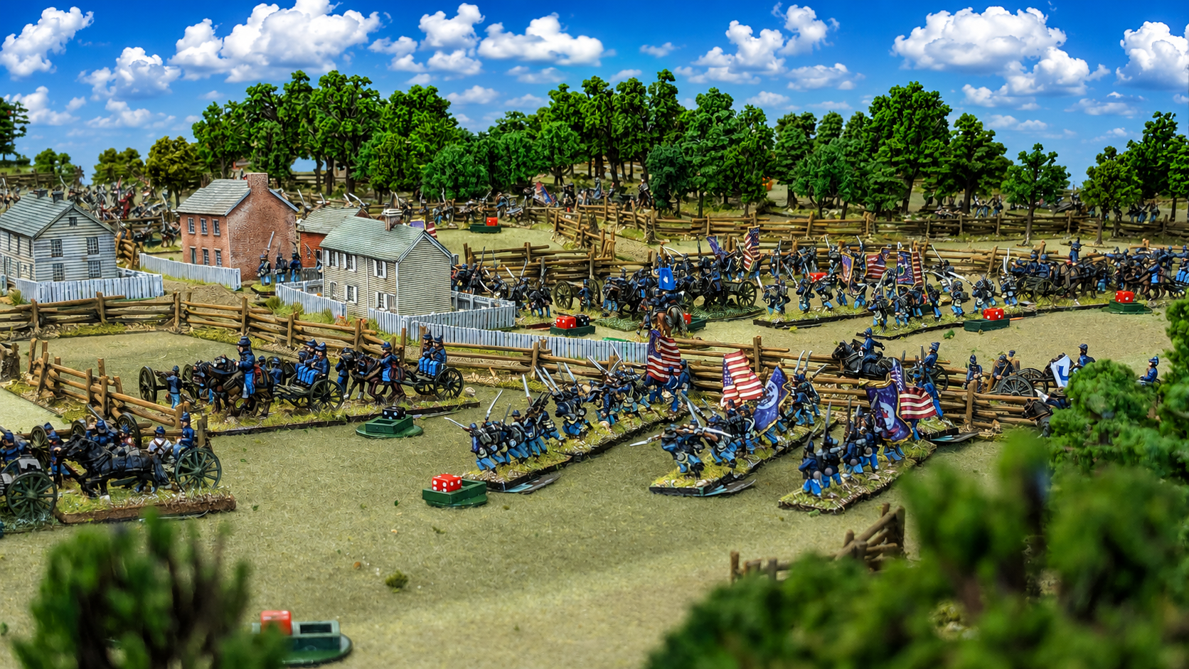 Miniature diorama of a Civil War battle scene with detailed soldiers, flags, cannons, and landscape.