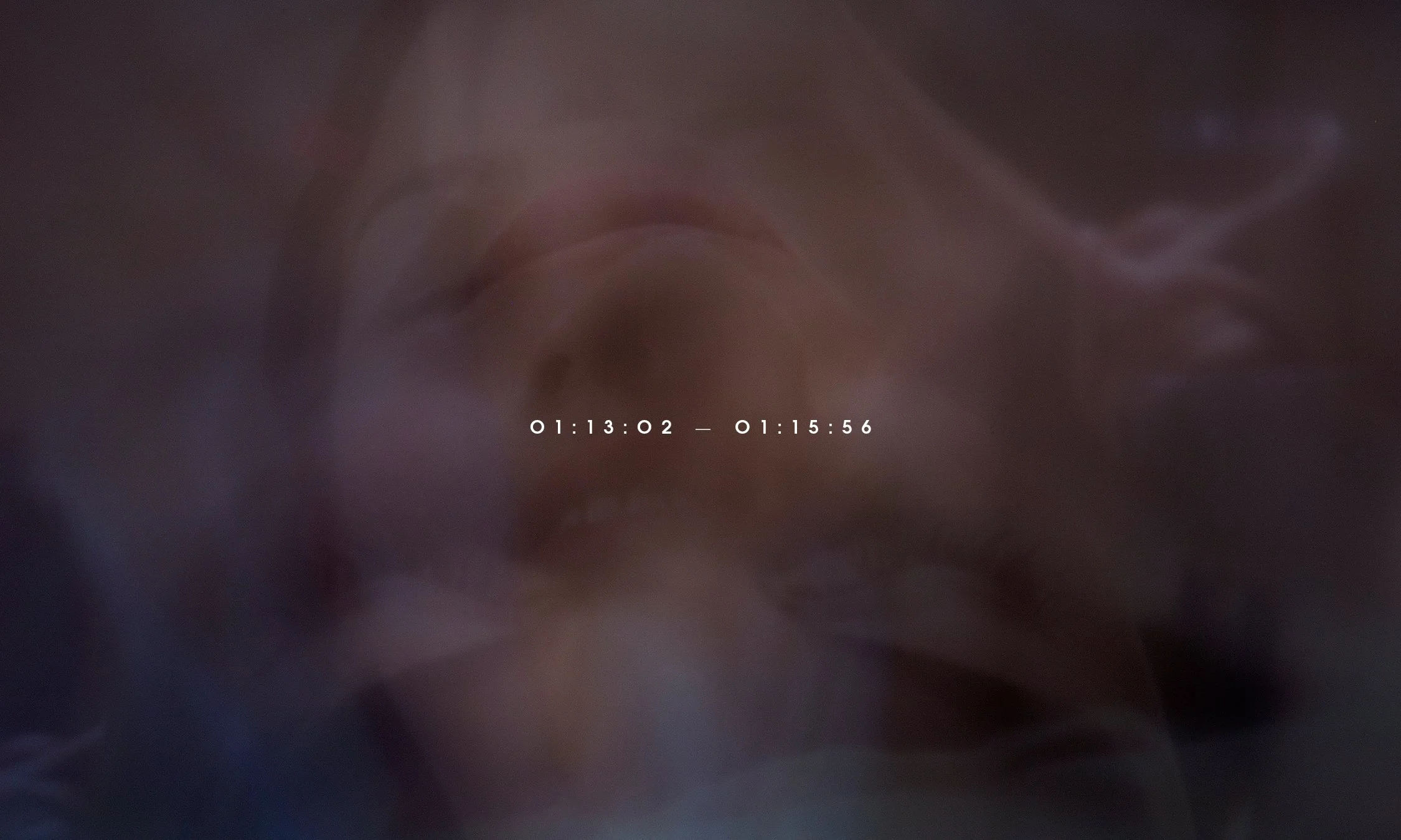 Blurred close-up of a face with a timestamp overlay in the center.