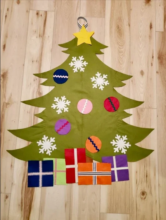 Handmade felt Christmas tree with colorful ornaments, snowflakes, and felt presents, designed as child-friendly holiday décor or an interactive play activity.