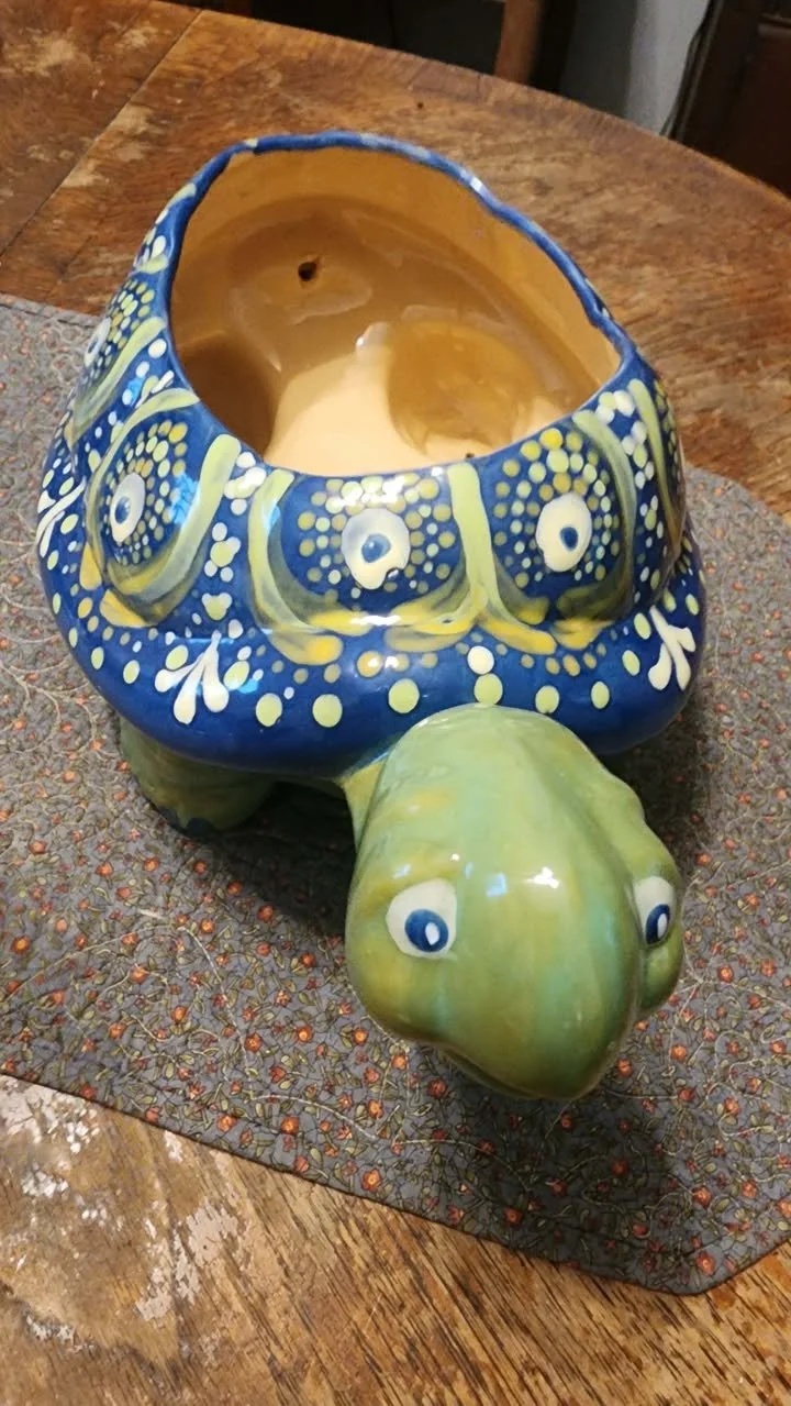 Ceramic turtle planter with a blue mandala‑style painted shell and an open top for holding plants.