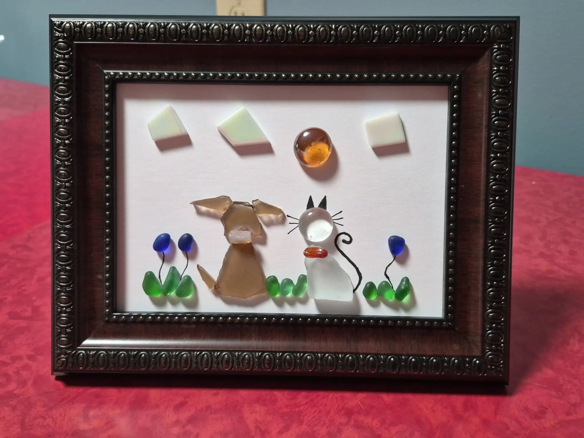 Handmade seaglass dog and cat artwork with flowers and sun