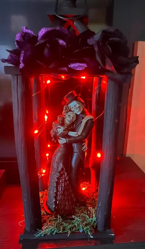 Handmade skeleton couple lantern décor with floral accents by This and That Crafts.