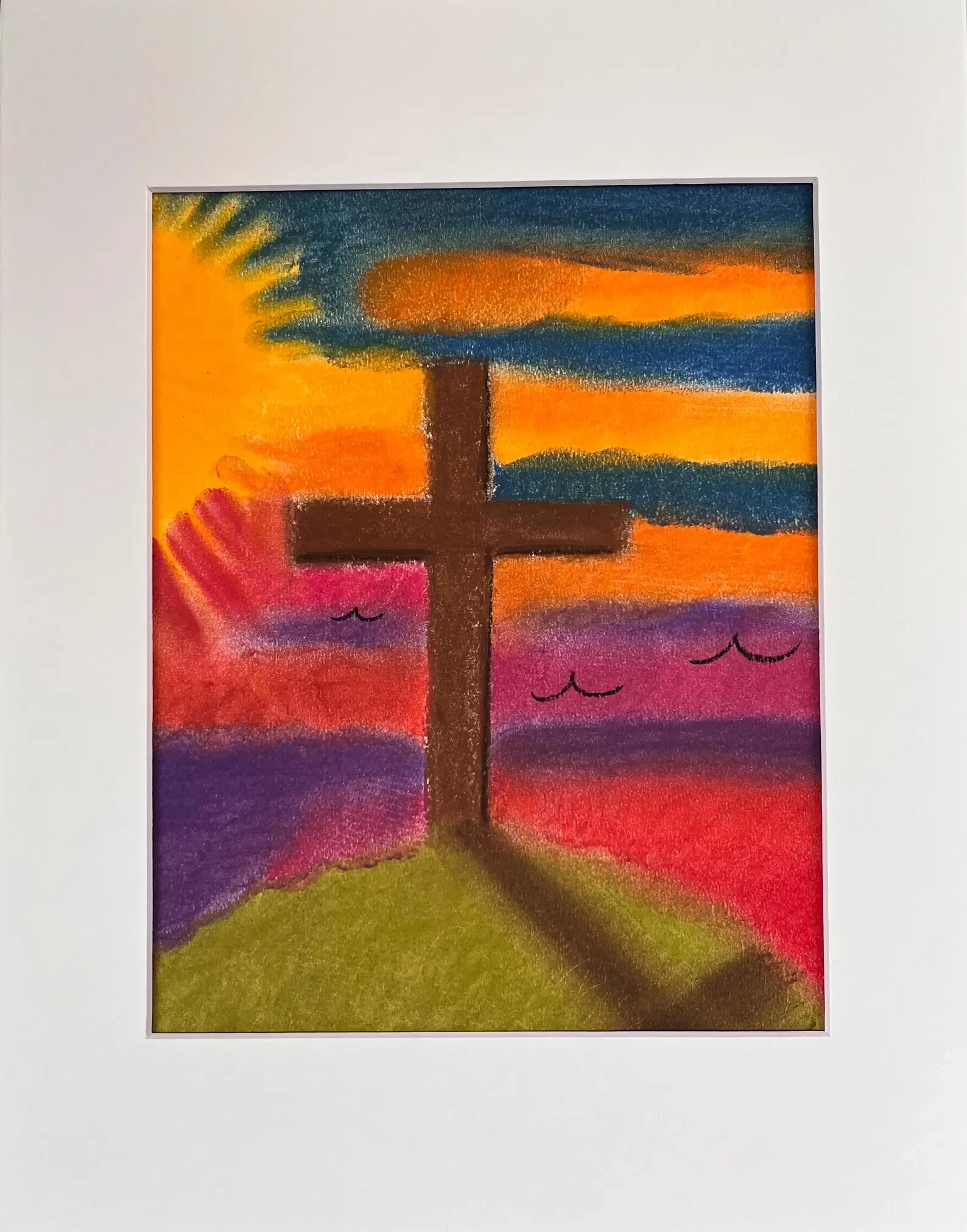 A colorful drawing of a brown cross on a green hill with a vibrant sunset sky blending yellow, orange, red, purple, and blue hues.