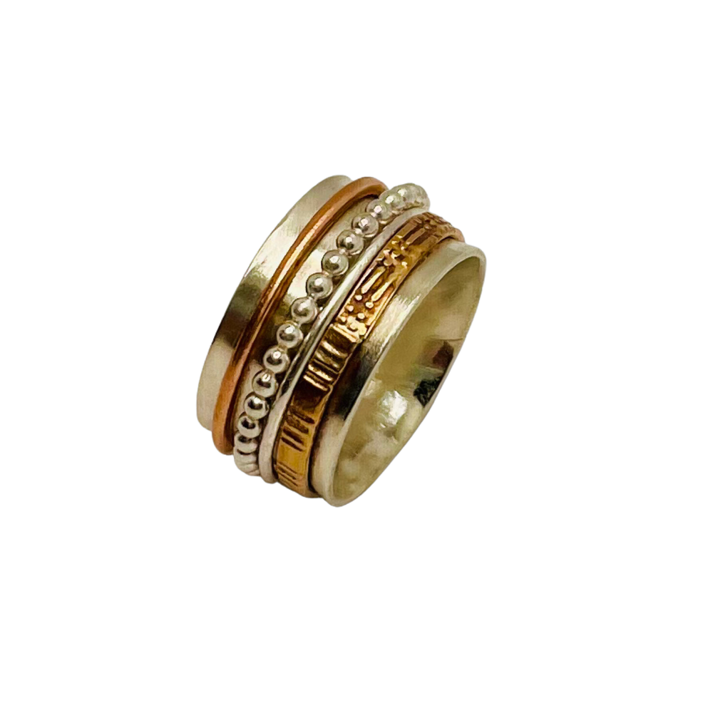 A handcrafted multi‑band ring featuring alternating silver and gold layers with engraved textures, dotted patterns, and raised metal accents.