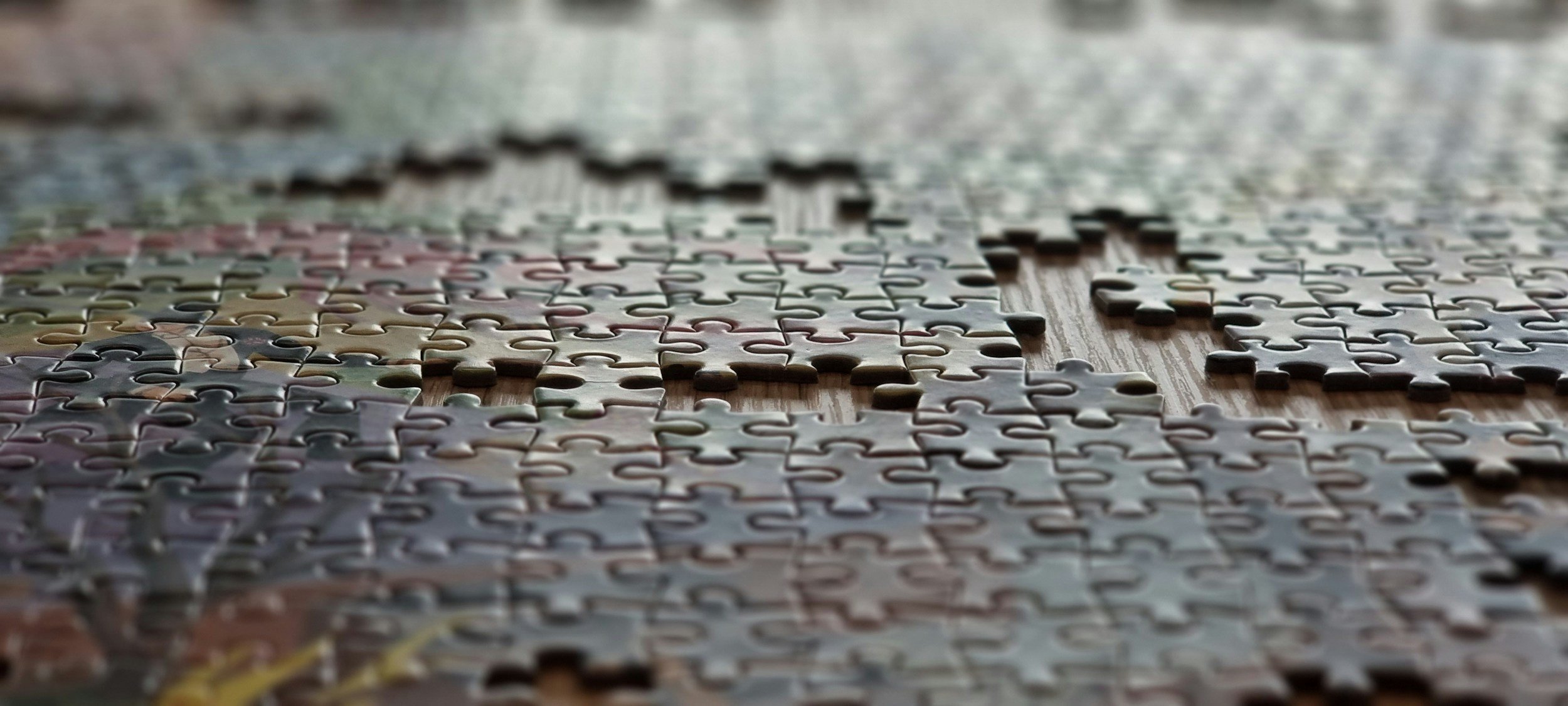 business elements fitting together to solve a puzzle