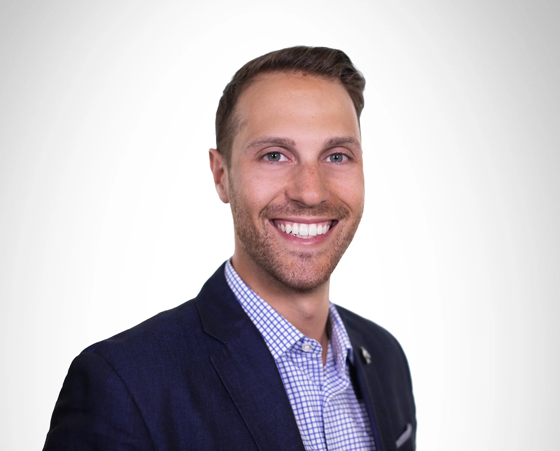 Headshot of Anthony D'Apice, small business consultant at Alpha Delta Consulting. Smiling in a dark suit jacket with short brown hair, posed against a plain white background.