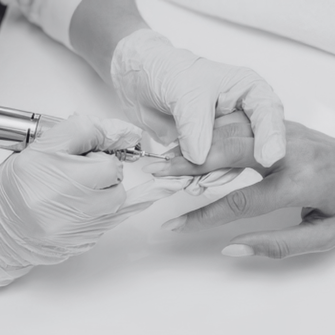 Close-up of a medical professional using a syringe to give an injection into a patient's finger, both wearing gloves.