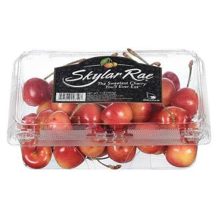 A clear plastic container of Skuller Rae cherries with a label that says 'Sweetest Cherry You'll Ever Eat'