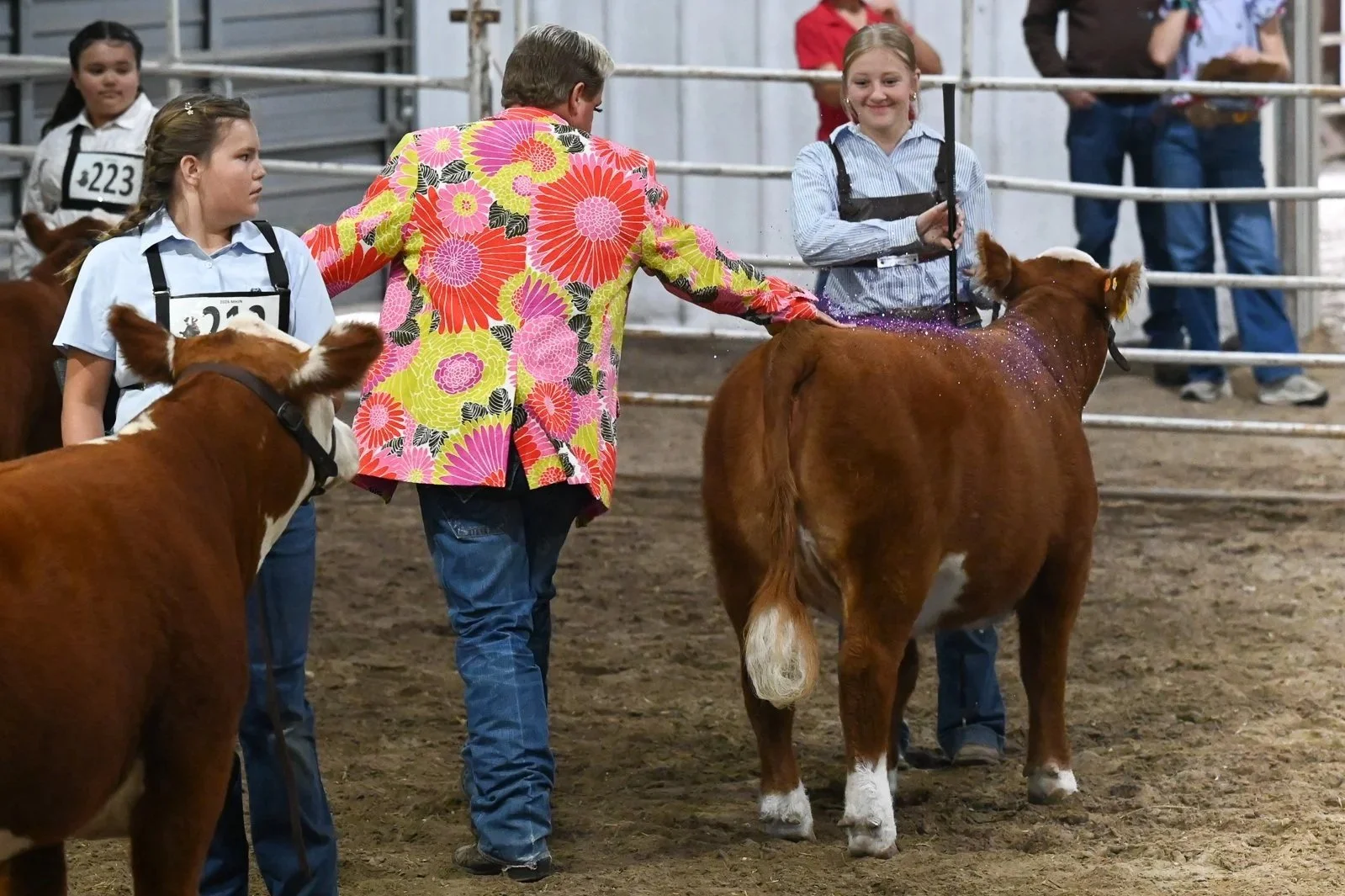 Ryan Rash giving the glitter slap to the Grand Champion Bred & Owned Heifer at the Miniature Hereford Junior Nationals