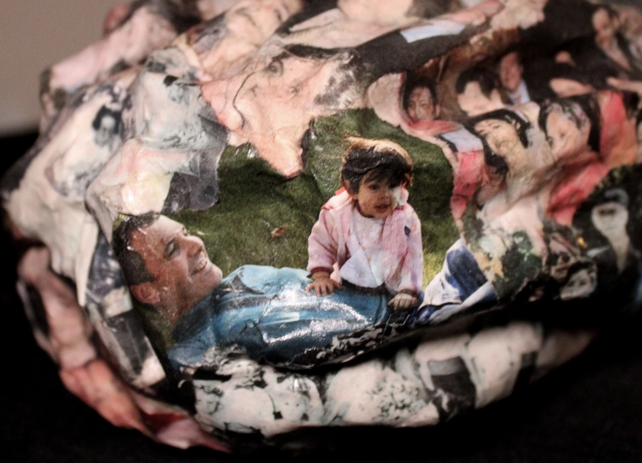 Close-up of a crumpled magazine featuring children, with two children visible and some printed text.