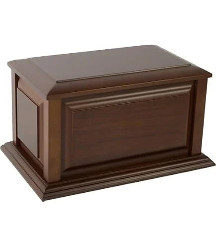 A wooden casket or box with a rectangular shape, dark brown finish, and decorative molding on the front panel.