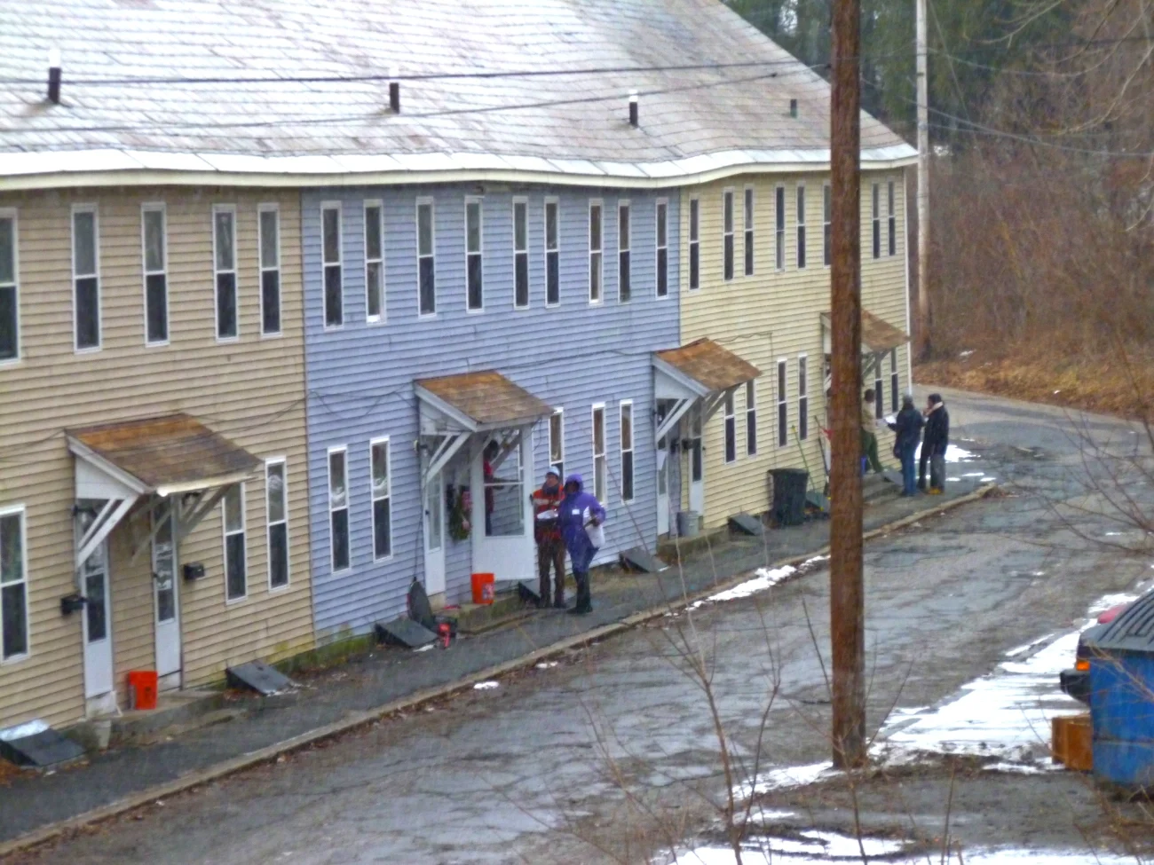 two teams of volunteers outside a set of row houses