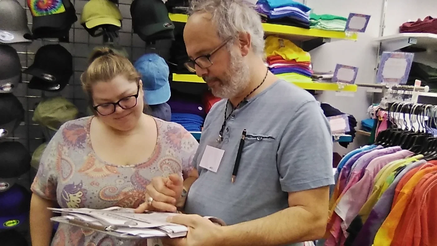 A man talking to a woman on a business canvass