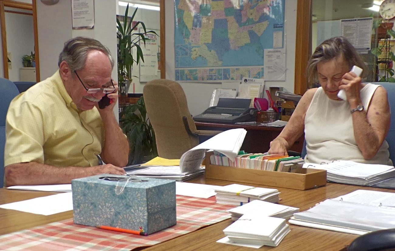Two volunteers on the phone at a phone training session