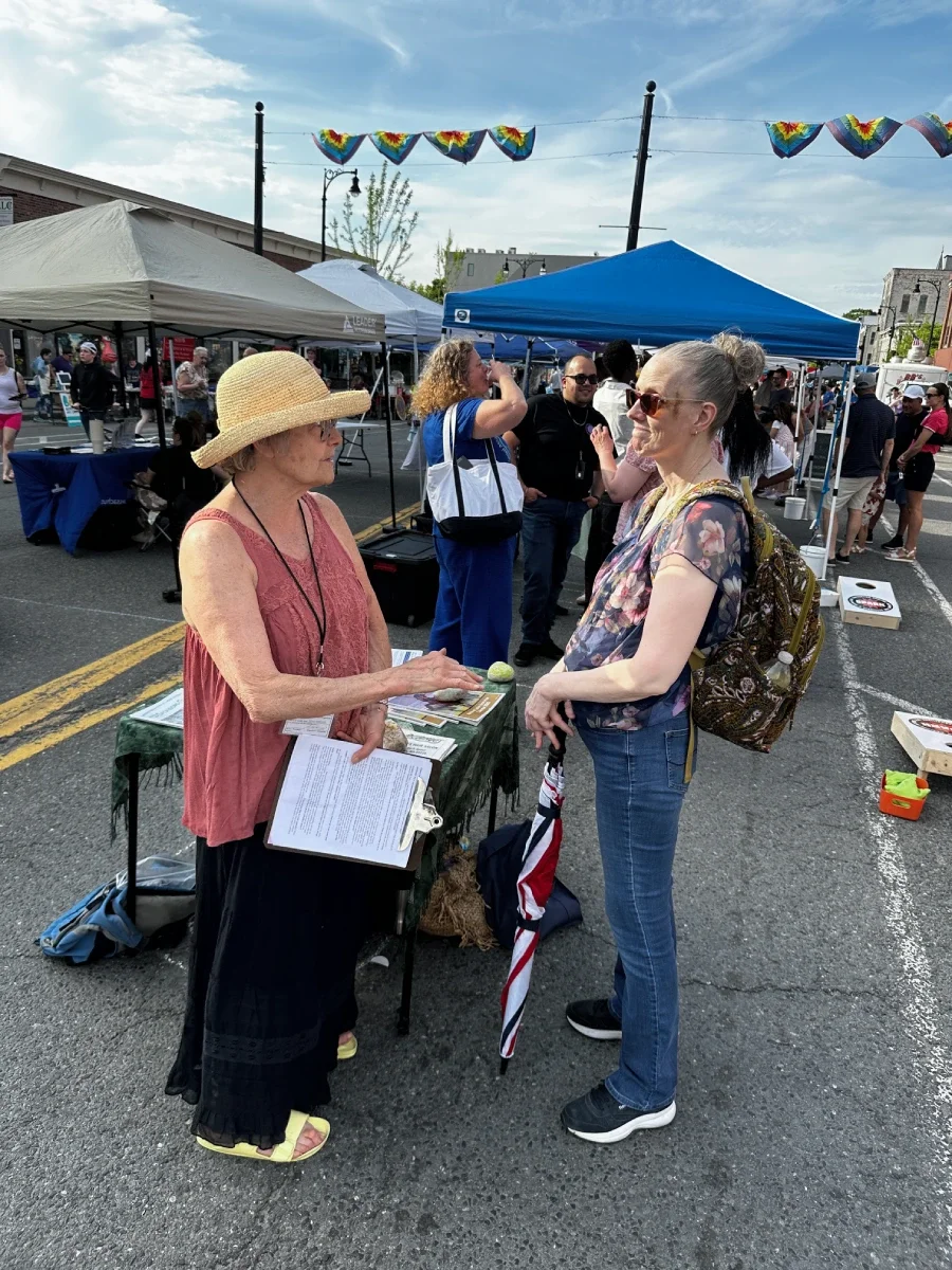 A female volunteer doing community outreach talking to a woman