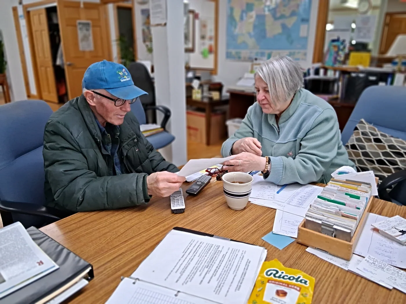 Two volunteers working on a mailout session