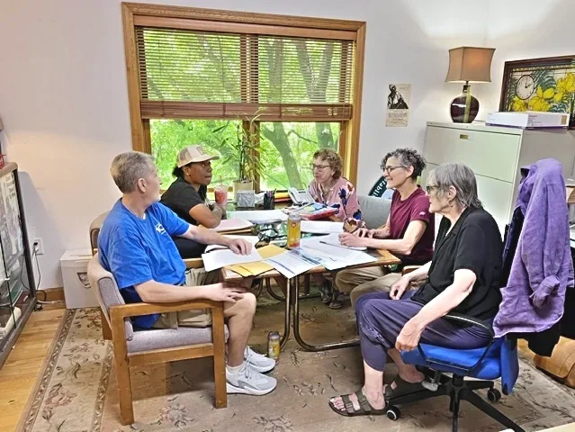 A group of WMLA volunteer working as a team to solve a benefit case for a member.
