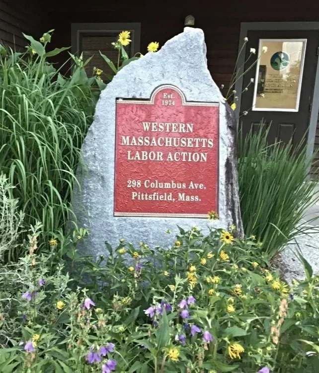 large stone with red inset with name and address of organization