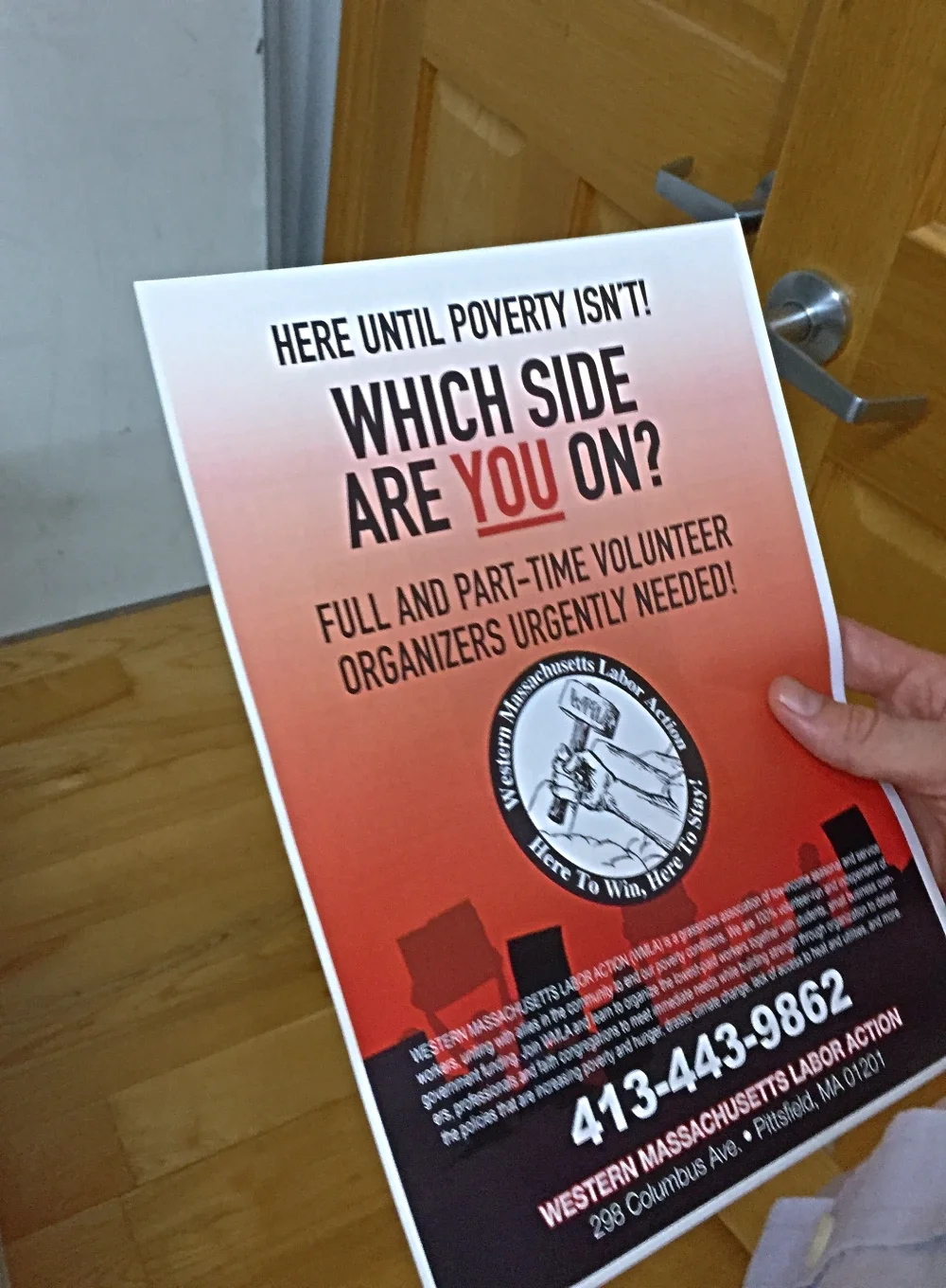 a hand holding a piece of WMLA literature