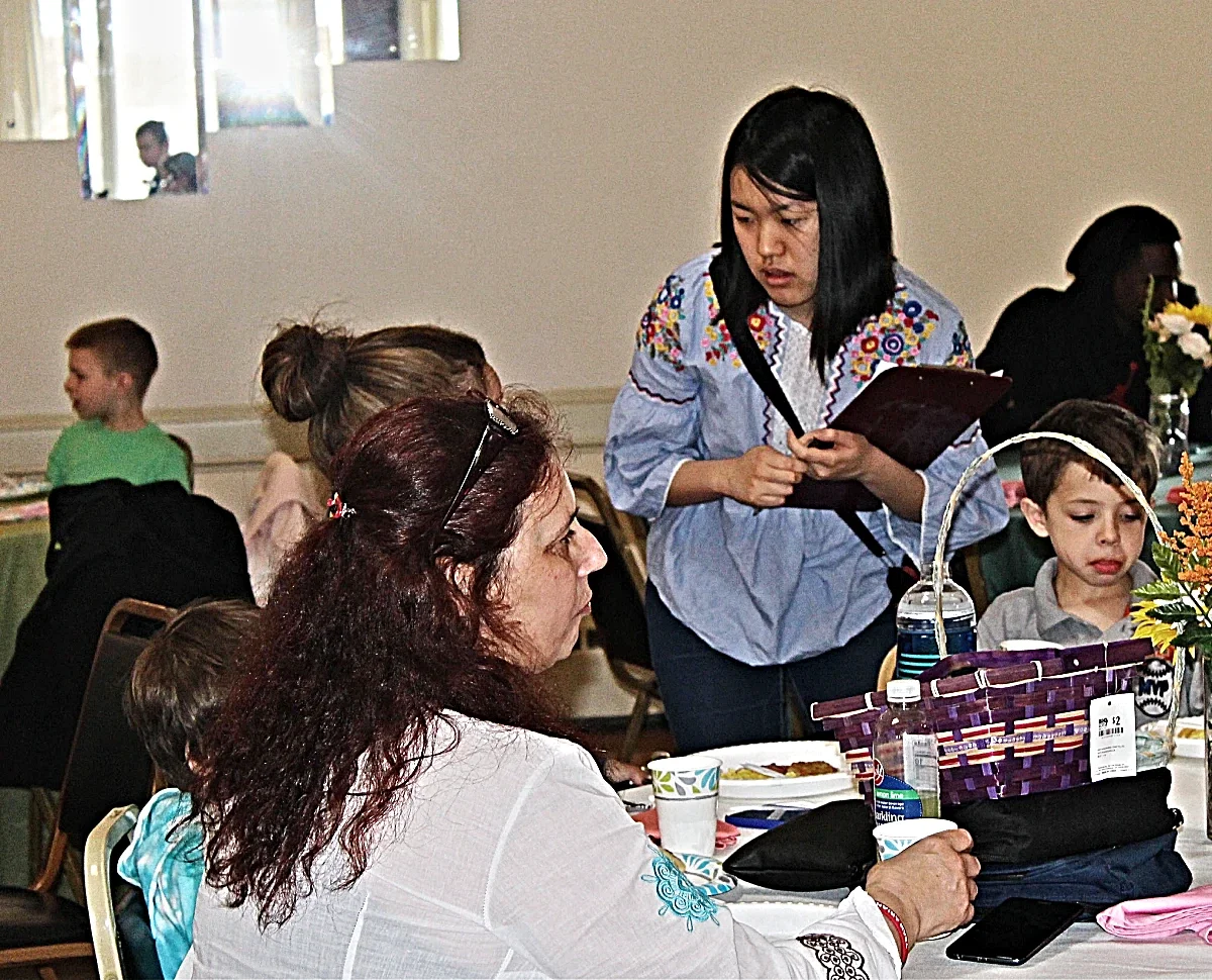 Woman with clipboard talking to another woman