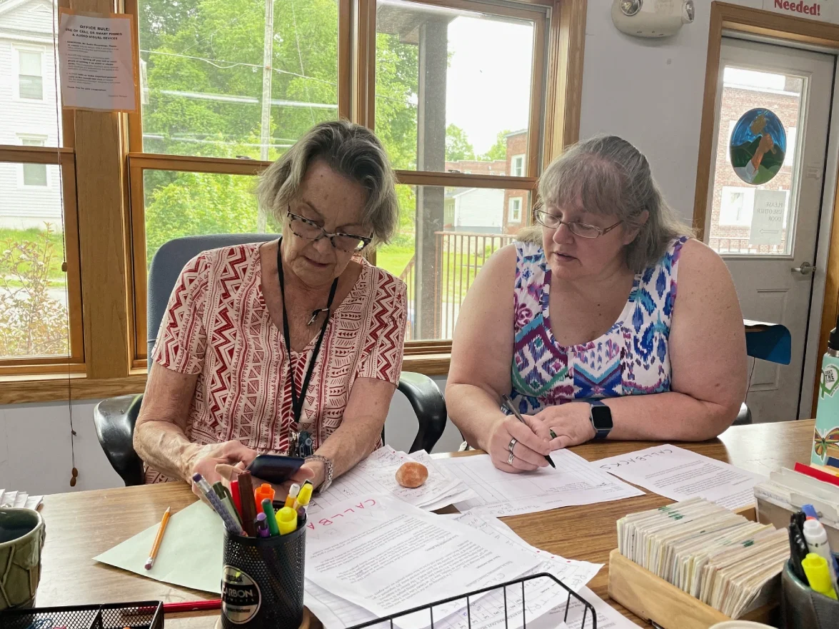 two volunteers working together on a legal benefit