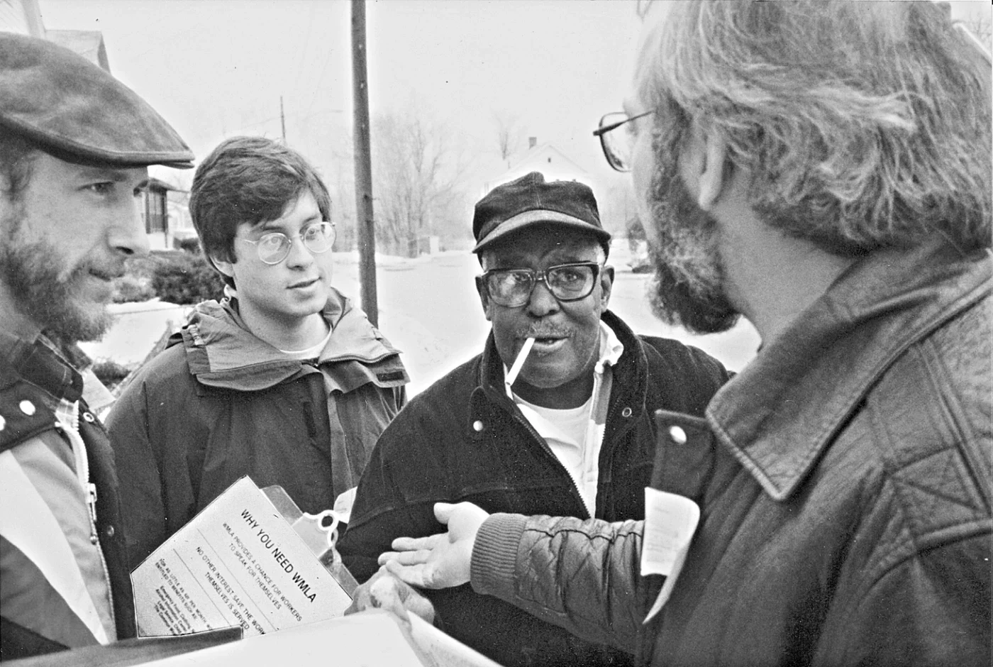 a volunteer talking to three other men