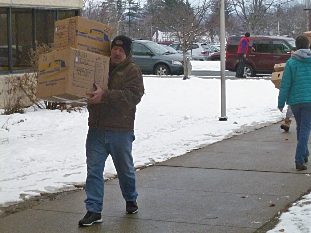 man carrying two boxes of food