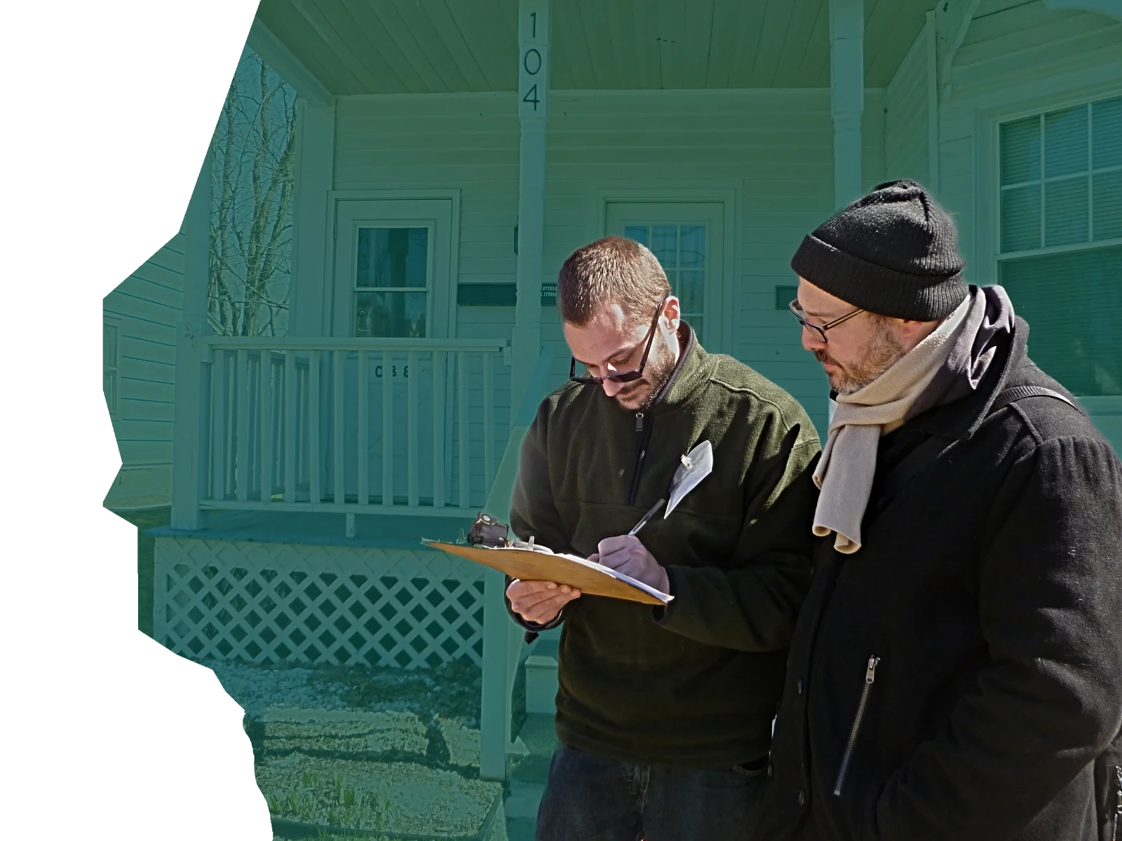 A volunteer stands with a man signing up as a new member