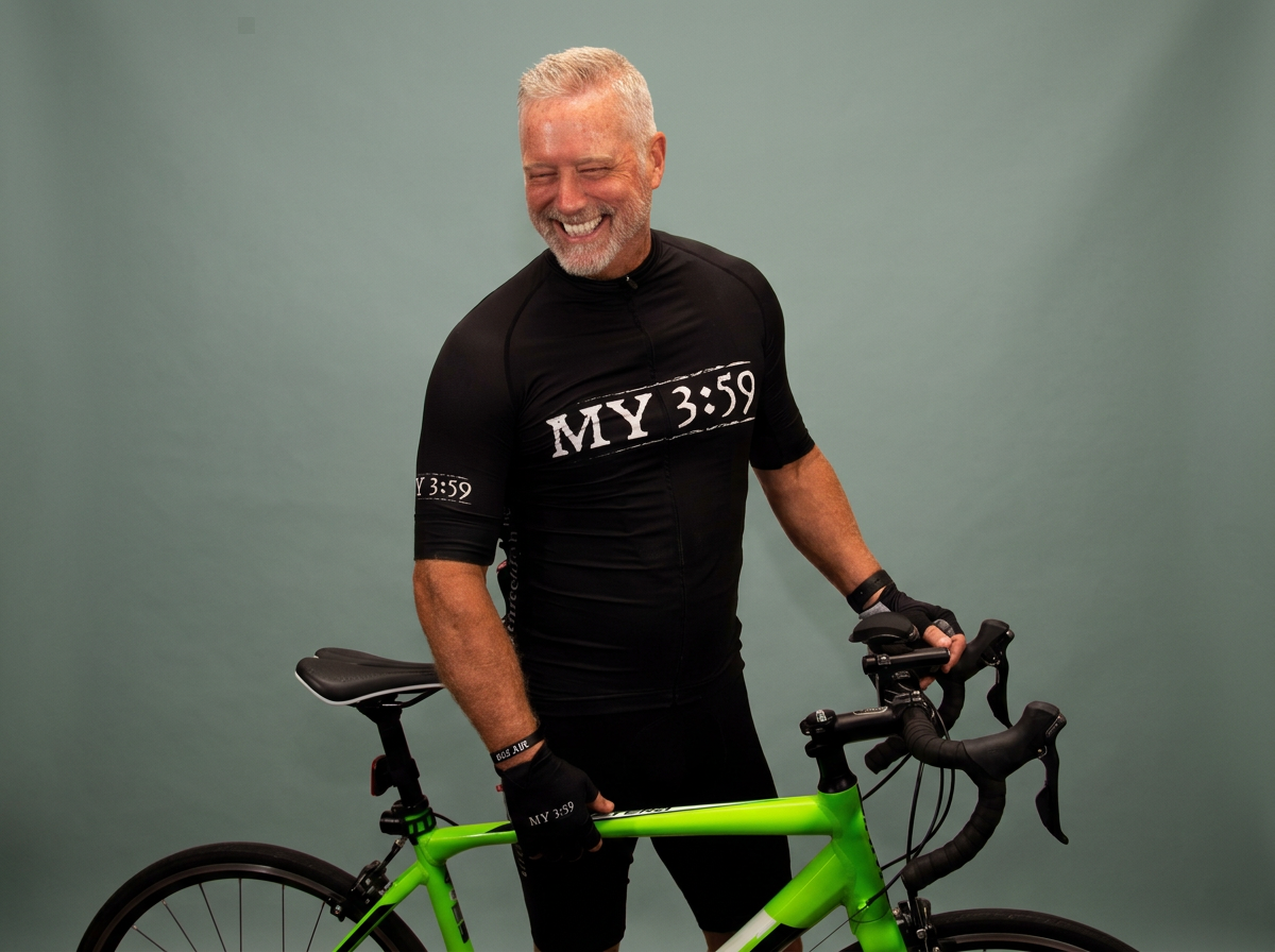 Doug Anderson, owner and CEO of The Dietitian's Office, pauses for an official photo with his bike while participating in an Ironman Triathlon.