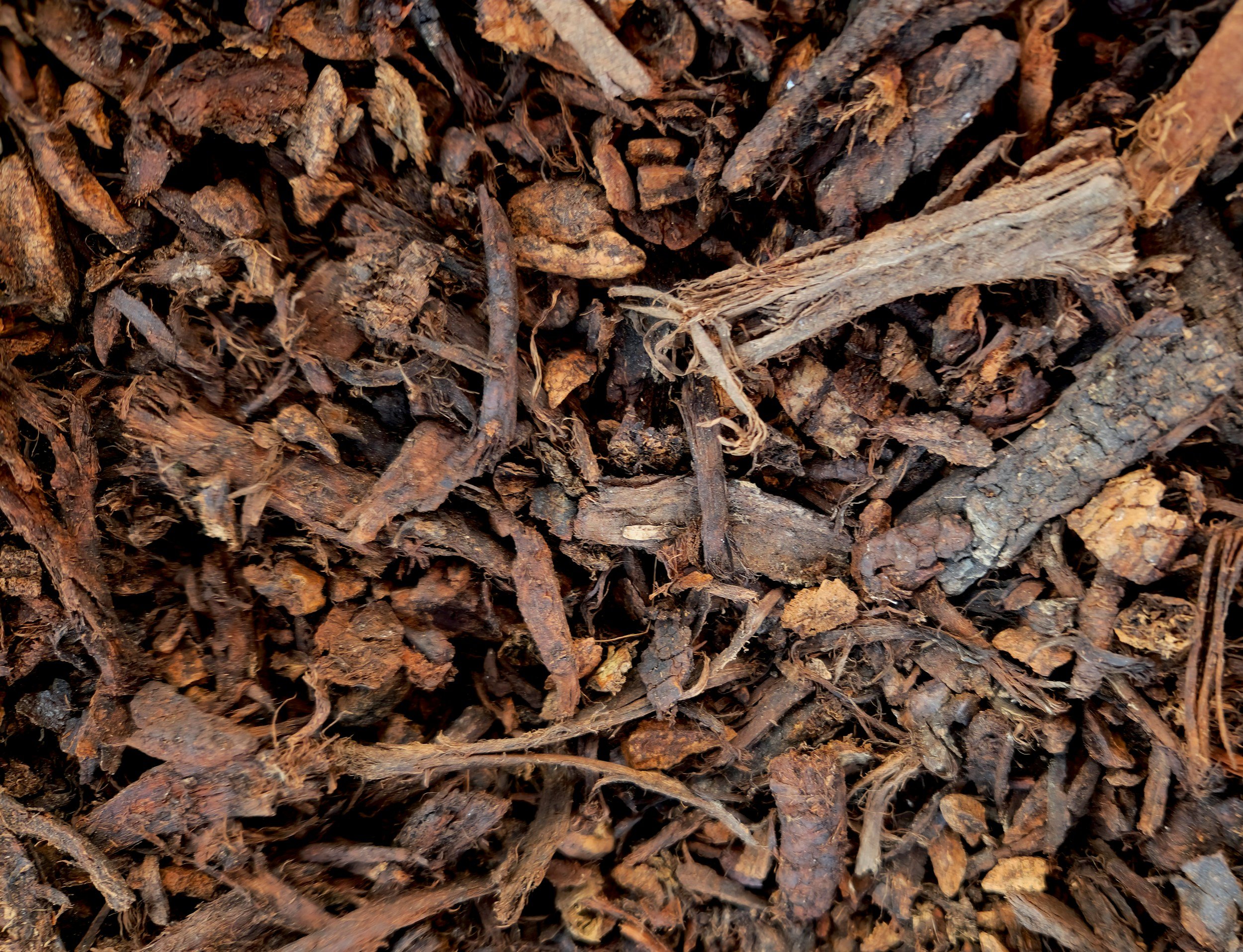 Close-up image of brown wood mulch or shredded bark used for landscaping.