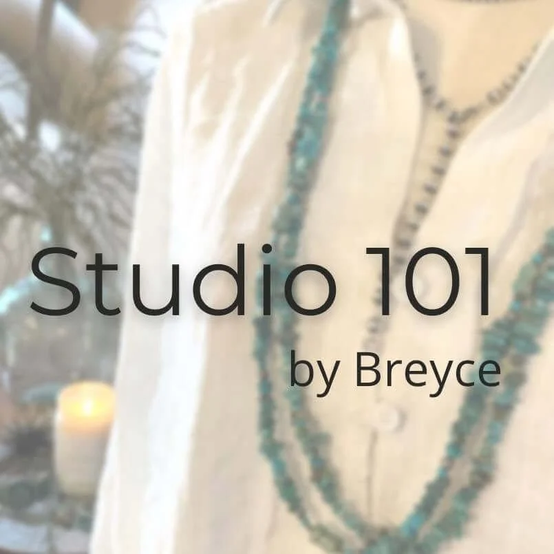 Text overlay on a background of a beaded necklace and a white fabric with a candle in the blurred background, reading 'Studio 101 by Breyce'.