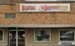 Facade of a building with signs for 'Mapleton' and 'Hometown Realty'