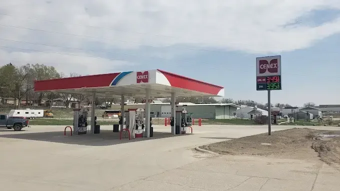 Cenex gas station with fuel pumps and price sign in a rural area.