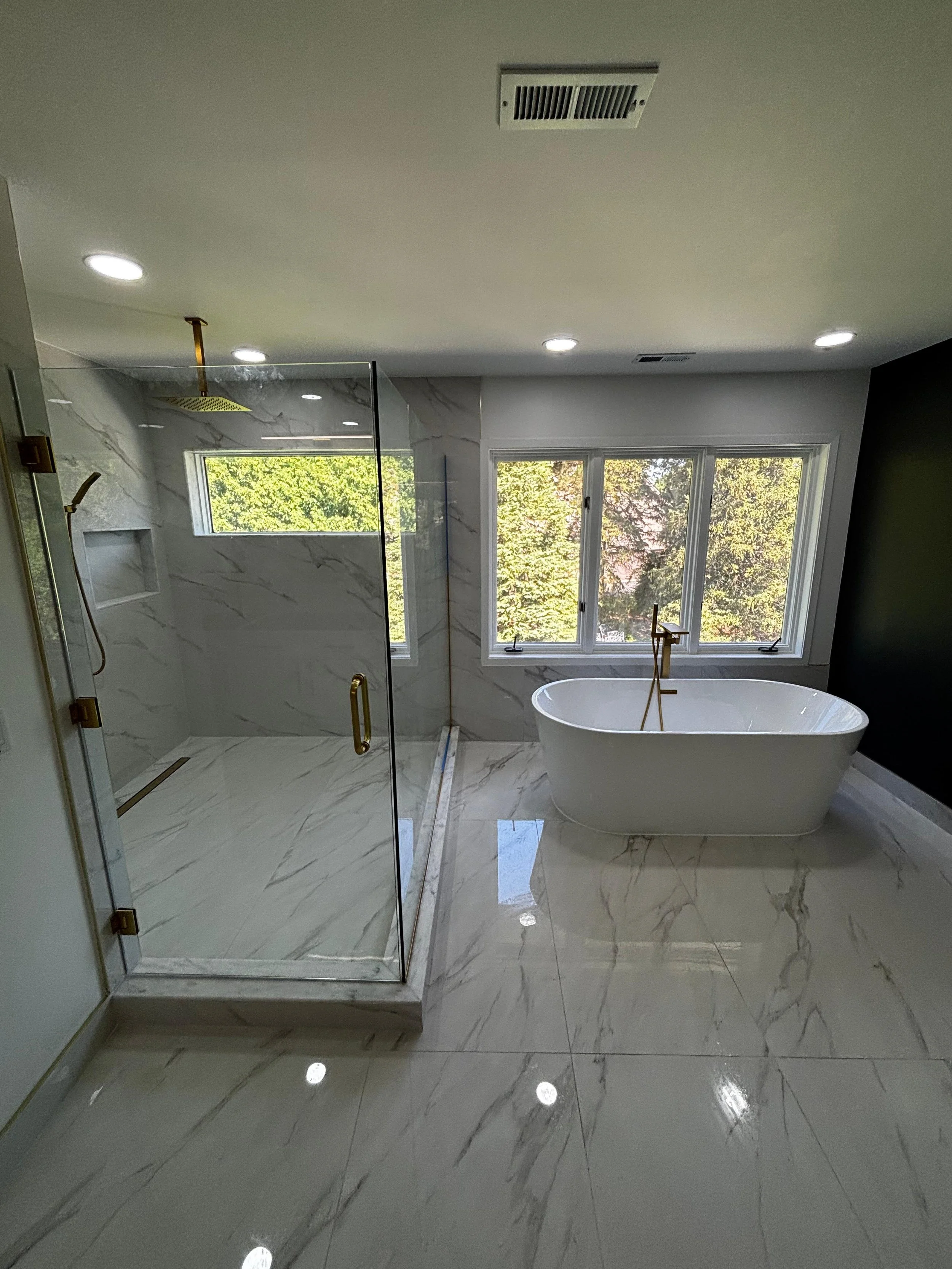 We completely renovated this bathroom with a spacious walk-in shower, elegant soaking tub, custom tile installation, and high-quality craftsmanship to create a bright and inviting space.