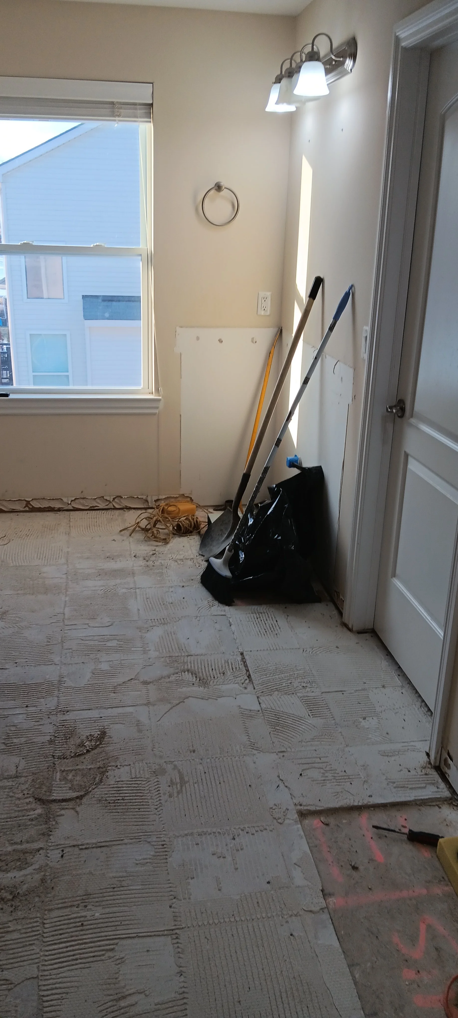 Bathroom interior during demolition with the original materials removed.